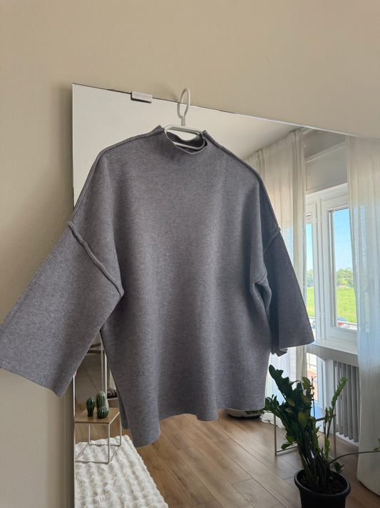 Maglione con cuciture in vista e manica a tre quarti